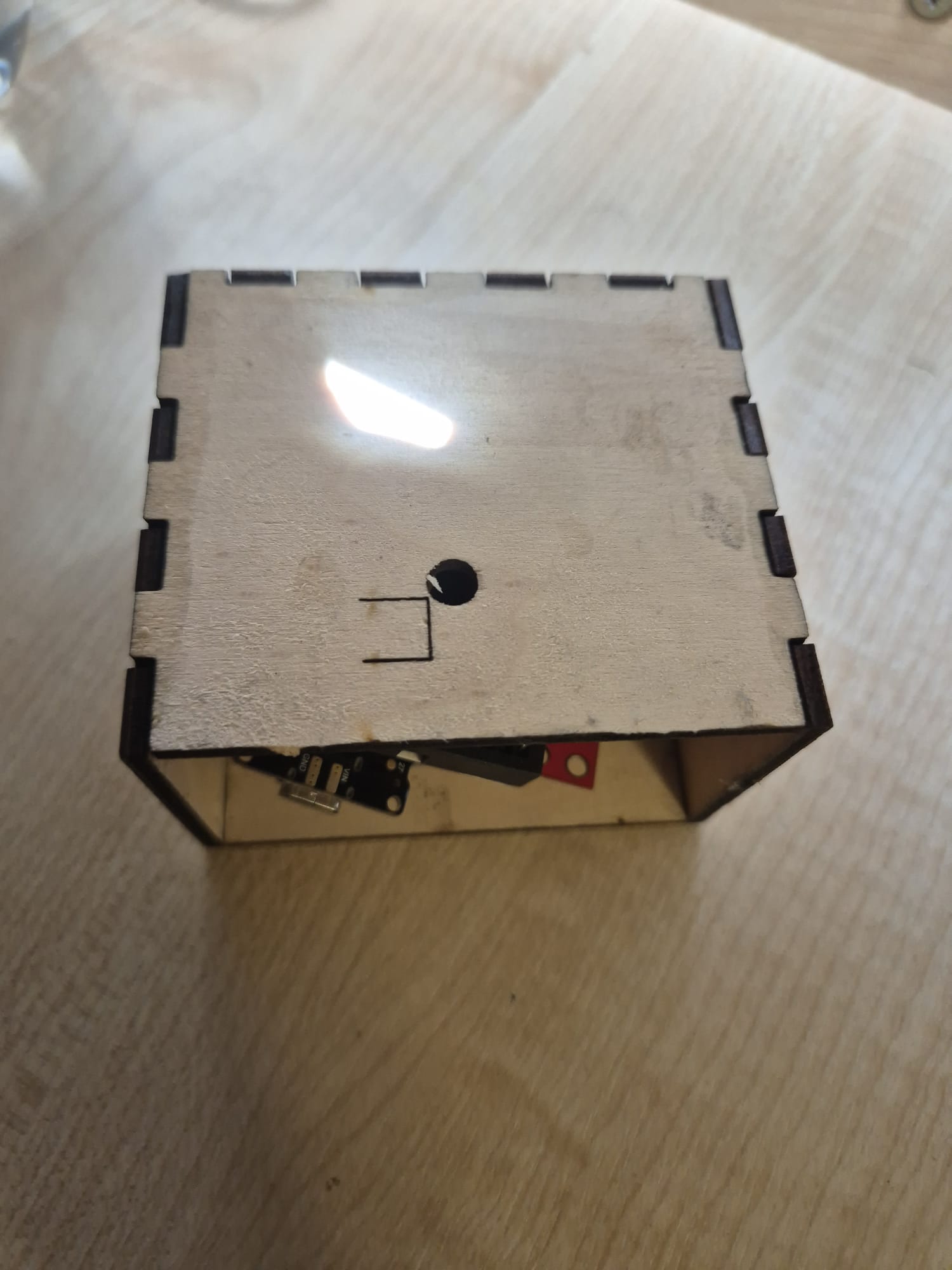 Finished enclosure, front view of the laser-cut wooden case with USB port cutout
